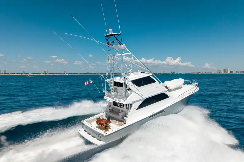 Slide: The Image of 2005 Viking 61 Enclosed Bridge yacht cruising on open blue waters. - 19