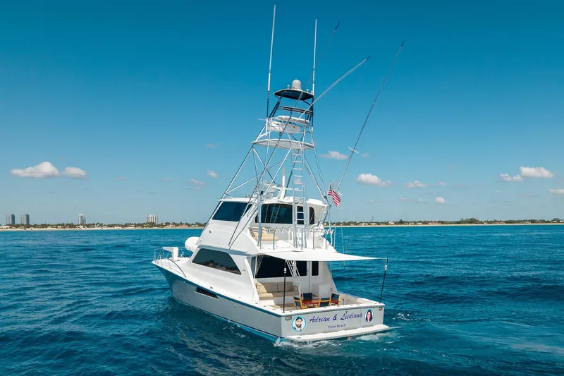 Slide: The Image of 2005 Viking 61 Enclosed Bridge yacht cruising on open blue waters. - 2