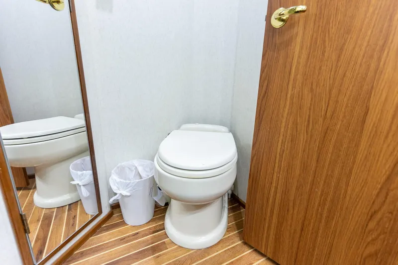 Slide: The Image of Bathroom interior of 2005 Viking 61 Enclosed Bridge yacht with wooden flooring. - 26