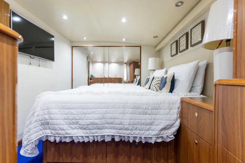 Slide: The Image of Luxurious bedroom interior on 2005 Viking 61 Enclosed Bridge yacht, featuring elegant decor. - 27