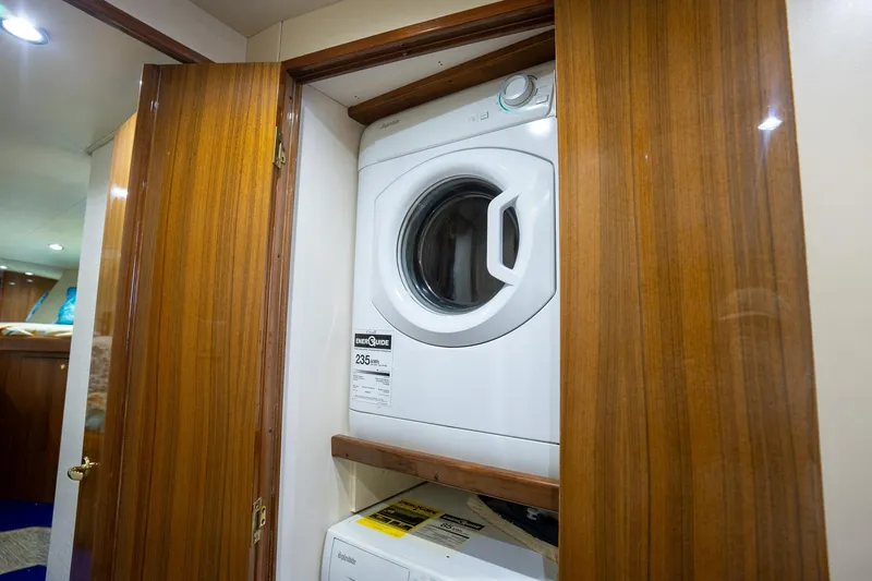 Slide: The Image of Laundry area with washer and dryer inside 2005 Viking 61 Enclosed Bridge yacht. - 29