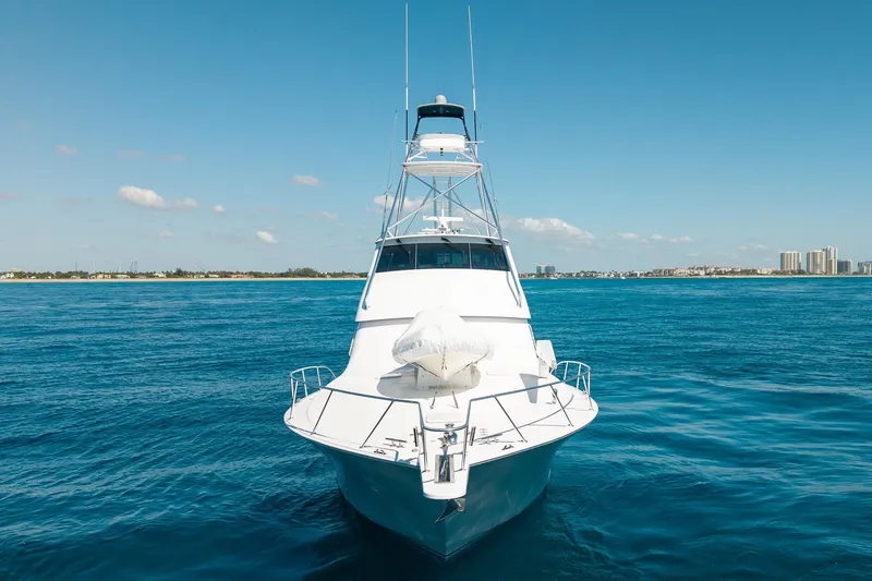 Slide: The Image of 2005 Viking 61 Enclosed Bridge yacht on open sea with clear blue sky. - 3