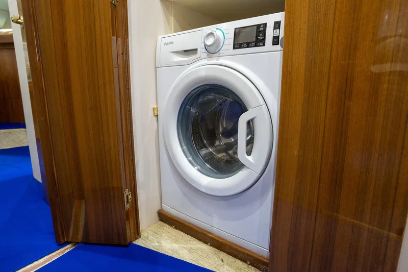 Slide: The Image of Washing machine inside 2005 Viking 61 Enclosed Bridge yacht's wooden cabinet. - 30