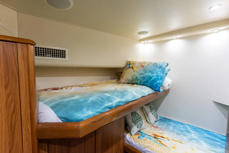 Slide: The Image of Cozy cabin interior of 2005 Viking 61 Enclosed Bridge yacht with bunk beds. - 31