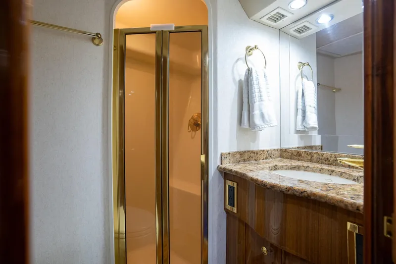 Slide: The Image of Luxurious bathroom interior of 2005 Viking 61 Enclosed Bridge yacht with granite countertop. - 33