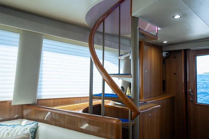 Slide: The Image of Interior of 2005 Viking 61 Enclosed Bridge yacht with spiral staircase and wooden cabinetry. - 38