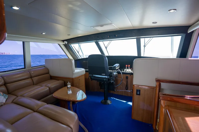 Slide: The Image of Luxurious interior of 2005 Viking 61 Enclosed Bridge yacht with leather seating and ocean view. - 39