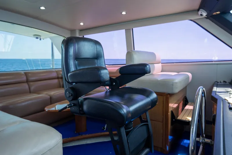 Slide: The Image of Interior of 2005 Viking 61 Enclosed Bridge yacht with leather seating and helm chair. - 42