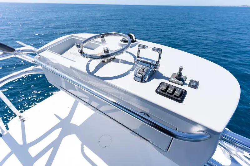 Slide: The Image of Control panel of a 2005 Viking 61 Enclosed Bridge yacht against a clear blue ocean. - 43