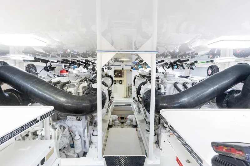 Slide: The Image of Engine room of 2005 Viking 61 Enclosed Bridge yacht, featuring dual engines and black exhaust pipes. - 45