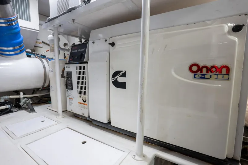 Slide: The Image of Engine room of 2005 Viking 61 Enclosed Bridge with Cummins Onan generator. - 47