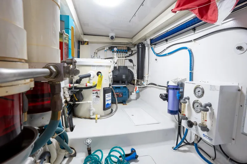 Slide: The Image of Engine room of 2005 Viking 61 Enclosed Bridge yacht with mechanical equipment and piping. - 48