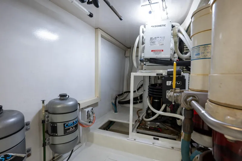 Slide: The Image of Engine room of 2005 Viking 61 Enclosed Bridge yacht with cooling systems and equipment. - 49