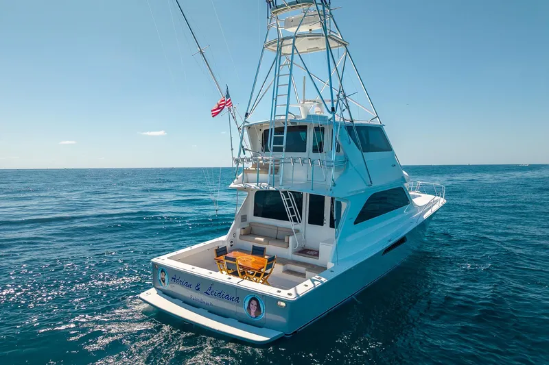 Slide: The Image of 2005 Viking 61 Enclosed Bridge yacht cruising on open sea under clear skies. - 5