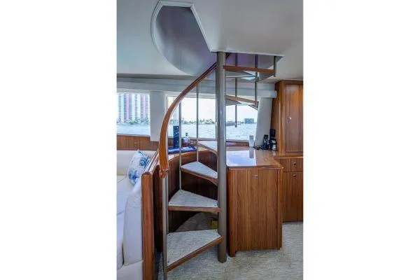 Slide: The Image of Interior of 2005 Viking 61 Enclosed Bridge yacht with spiral staircase and wooden cabinetry. - 51