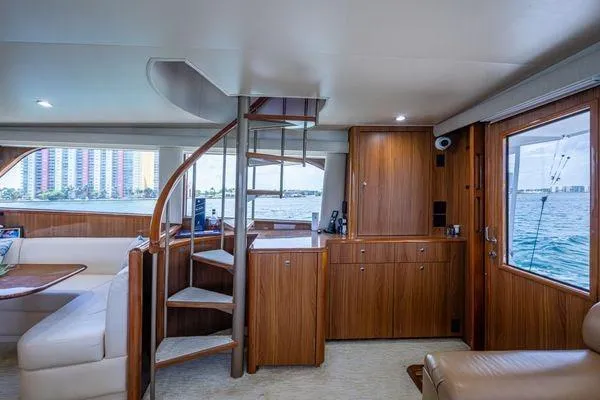 Slide: The Image of Interior of 2005 Viking 61 Enclosed Bridge yacht with wooden cabinetry and spiral staircase. - 53
