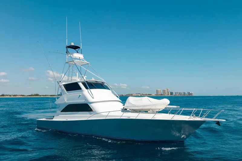 Slide: The Image of 2005 Viking 61 Enclosed Bridge yacht cruising on open blue waters. - 9