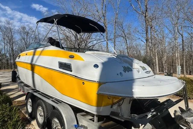 Slide: The Image of 2003 Crownline 270 BR boat with yellow and white exterior on a trailer. - 11