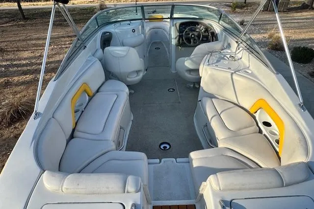 Slide: The Image of 2003 Crownline 270 BR boat interior with white seating and yellow accents. - 12