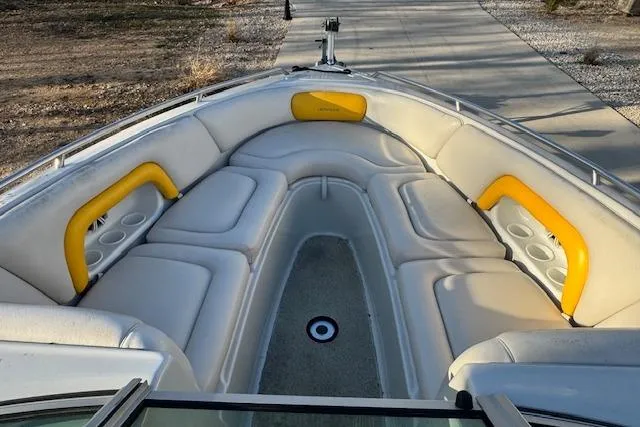 Slide: The Image of 2003 Crownline 270 BR boat interior with white and yellow seating. - 13