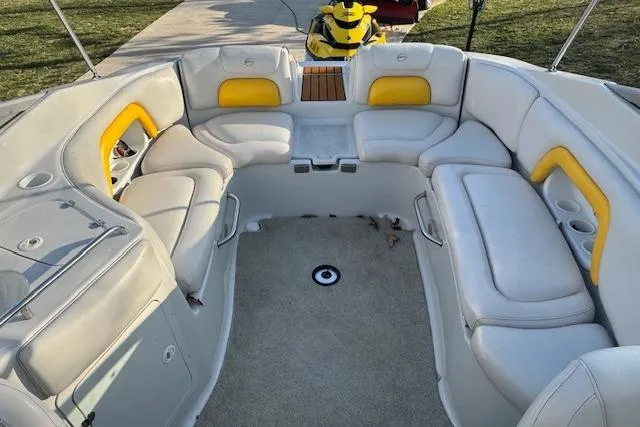 Slide: The Image of 2003 Crownline 270 BR boat interior with white and yellow seating arrangement. - 14