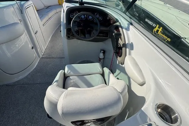 Slide: The Image of 2003 Crownline 270 BR boat cockpit with steering wheel and seating. - 16
