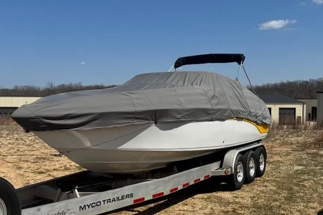 Slide: The Image of Covered 2003 Crownline 270 BR boat on trailer under clear sky. - 24