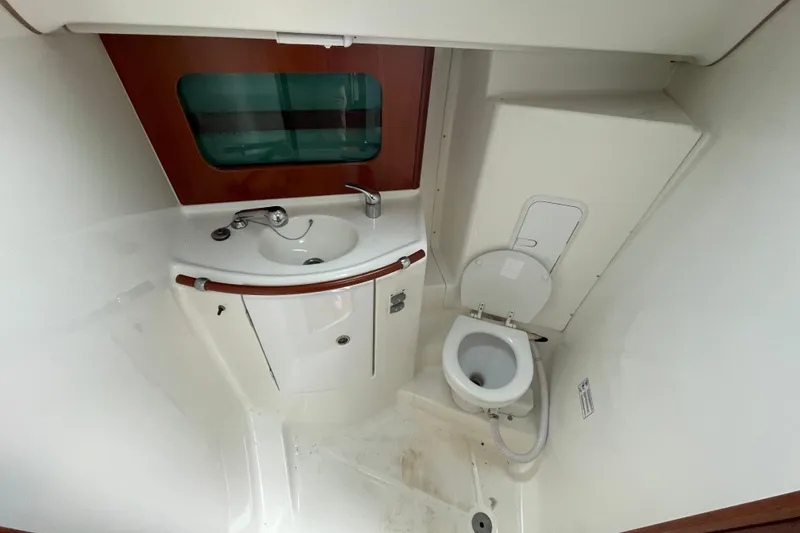 Slide: The Image of Compact bathroom in a 2002 Beneteau 331 sailboat, featuring a sink and toilet. - 20