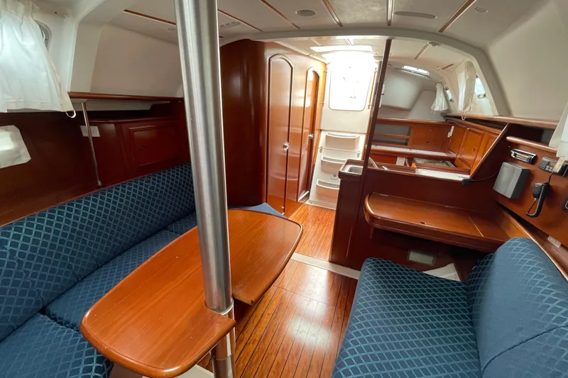 Slide: The Image of Interior of 2002 Beneteau 331 sailboat with wood finish and blue upholstery. - 22