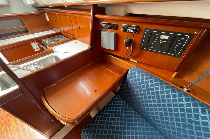 Slide: The Image of Interior of 2002 Beneteau 331 sailboat with navigation station and galley area. - 23