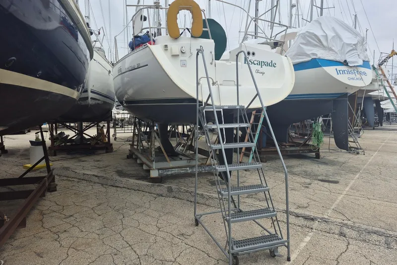 Slide: The Image of Beneteau 331 sailboat from 2002 on dry dock with access ladder. - 3