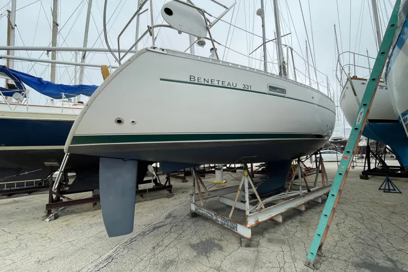 Slide: The Image of 2002 Beneteau 331 sailboat on dry dock, ready for maintenance and inspection. - 6