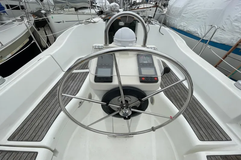 Slide: The Image of Steering wheel of a 2002 Beneteau 331 sailboat with navigation instruments. - 8