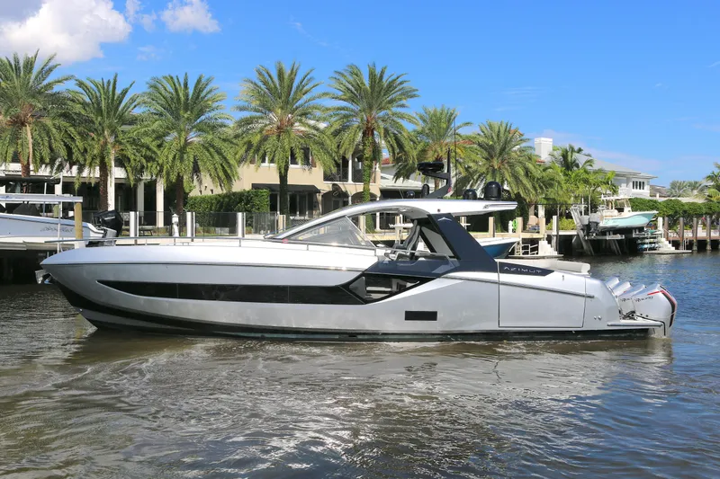 The Image of 2023 Azimut Verve 47 yacht docked near palm trees and waterfront homes. - 0