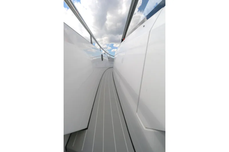 Slide: The Image of 2023 Azimut Verve 47 yacht deck with sleek white design and cloudy sky. - 11