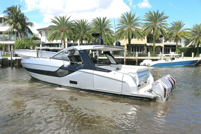 Slide: The Image of 2023 Azimut Verve 47 yacht docked near palm trees and waterfront homes. - 21