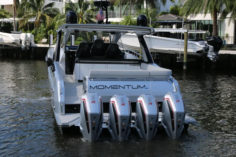 Slide: The Image of 2023 Azimut Verve 47 boat with four powerful outboard engines docked in a marina. - 22