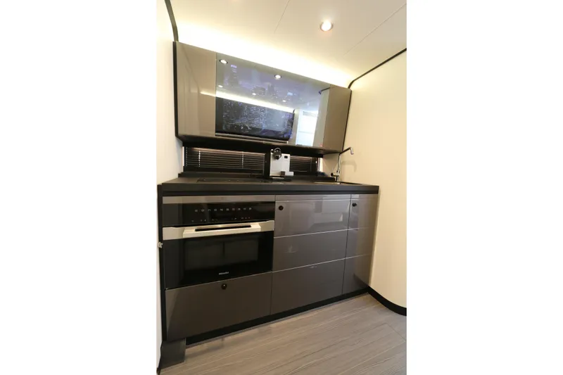 Slide: The Image of Modern kitchen interior on 2023 Azimut Verve 47 yacht, featuring sleek cabinetry and appliances. - 7