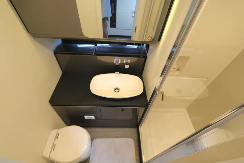Slide: The Image of Modern bathroom interior on 2023 Azimut Verve 47 yacht, featuring sleek sink and shower. - 9