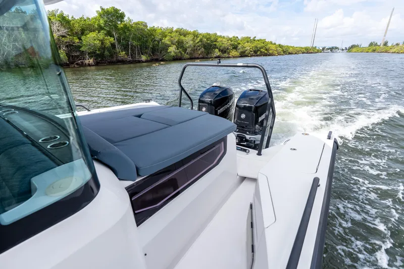 Slide: The Image of 2022 Axopar 37 XC Cross Cabin cruising on a scenic waterway. - 11