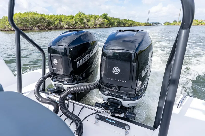 Slide: The Image of Twin Mercury outboard engines on 2022 Axopar 37 XC Cross Cabin boat cruising on water. - 13