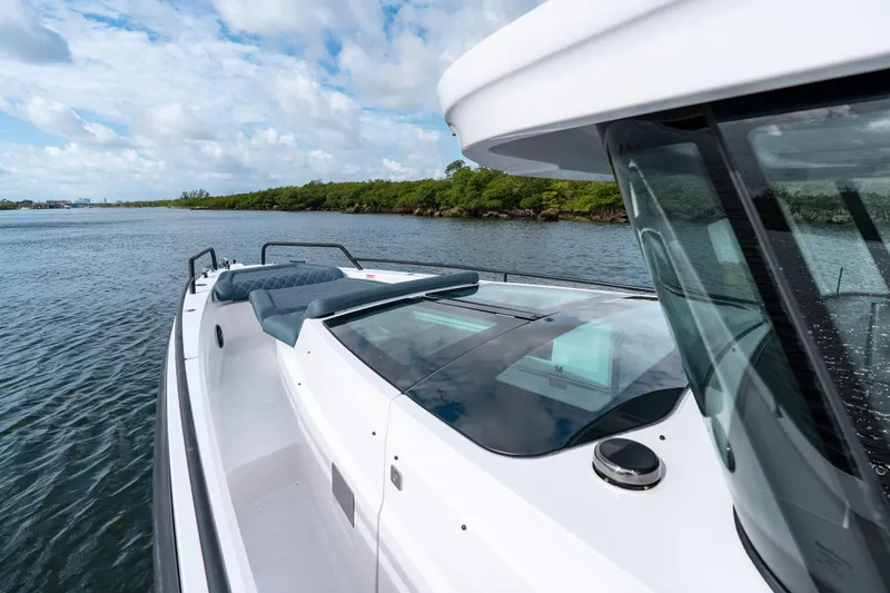 Slide: The Image of 2022 Axopar 37 XC Cross Cabin boat on calm water, featuring sleek design and modern amenities. - 16