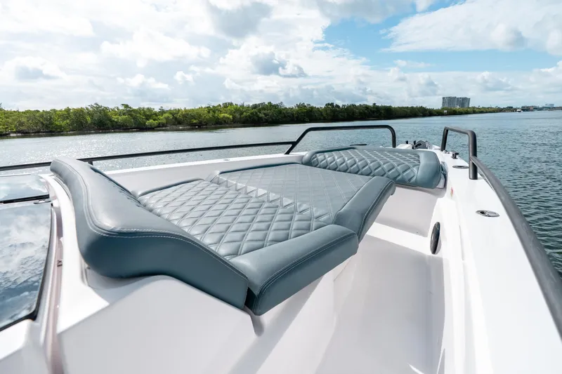 Slide: The Image of 2022 Axopar 37 XC Cross Cabin boat with luxurious seating on a sunny day. - 18