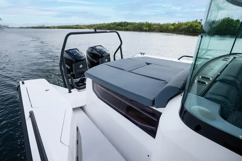 Slide: The Image of 2022 Axopar 37 XC Cross Cabin boat with dual Mercury engines on a serene waterway. - 20