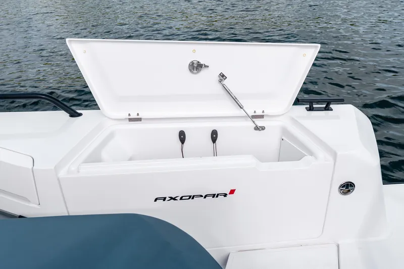 Slide: The Image of 2022 Axopar 37 XC Cross Cabin storage compartment open on water. - 22