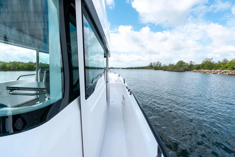 Slide: The Image of 2022 Axopar 37 XC Cross Cabin cruising on a scenic waterway. - 25