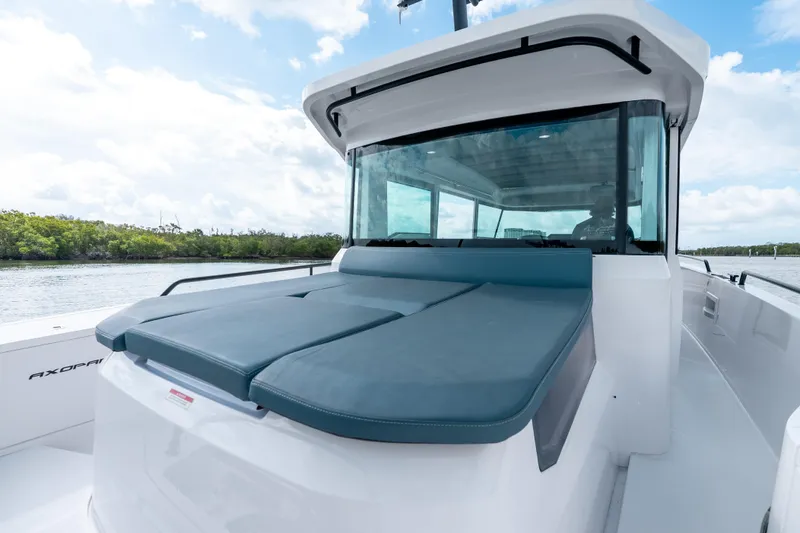 Slide: The Image of 2022 Axopar 37 XC Cross Cabin boat with sleek design on calm water. - 26