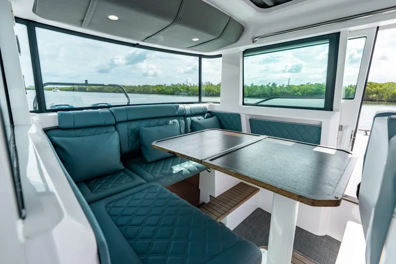 Slide: The Image of Luxurious interior of 2022 Axopar 37 XC Cross Cabin with plush seating and scenic views. - 30