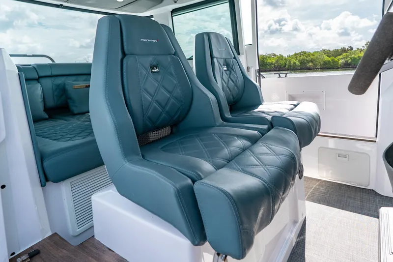 Slide: The Image of Luxurious interior seating of 2022 Axopar 37 XC Cross Cabin boat, featuring quilted leather upholstery. - 31