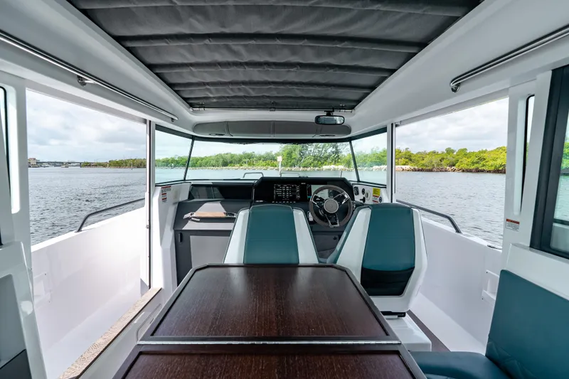 Slide: The Image of Interior view of 2022 Axopar 37 XC Cross Cabin, featuring sleek design and waterfront scenery. - 32